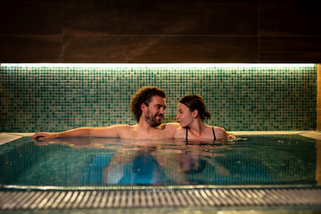 Couple relaxing in spa center hot tub