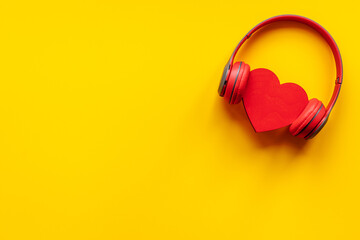Red headphones with heart shape, top view. Love music concept
