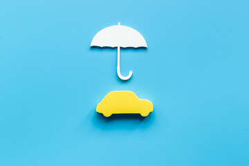 Car shape under umbrella. Insurance and car propection concept