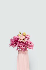 Bouquet of eustoma flowers in front of blue pastel background. Springtime still life with copyspace.