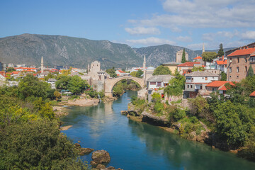 Fototapeta na wymiar Classic view of Stari Most over the Neretva River the old town of Mostar, Bosnia & Herzegovina, on a clear sunny summer day.