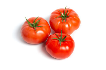 a few tomatoes on a white background with a shadow.