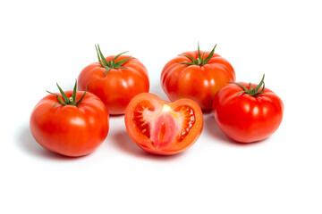 a group of tomatoes on a white background, with shadows. One tomato cut, studio photo, isolate, tomatoes washed