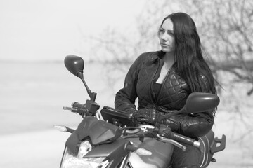 Fototapeta na wymiar young woman on a motorcycle