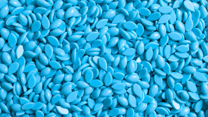 Background texture of blue depilatory wax. Depilation wax granules. Epilation, depilation, unwanted hair removal. Top view. Place for text.