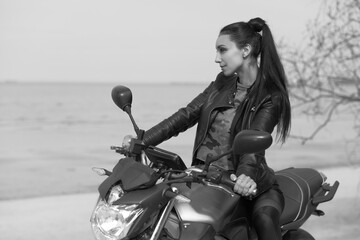 Fototapeta na wymiar young woman on a motorcycle