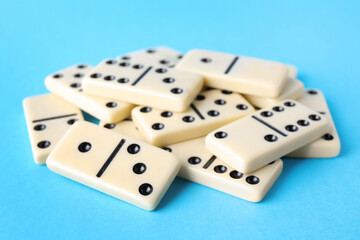 White domino tiles on turquoise background, closeup
