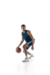 Fototapeta na wymiar Leader. Young arabian muscular basketball player in action, motion isolated on white background. Concept of sport, movement, energy and dynamic, healthy lifestyle. Training, practicing.