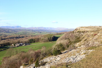 Naklejka premium View from Scout Scar, Cumbria, across the Lyth Valley towards the mountains of the central Lake District National Park.