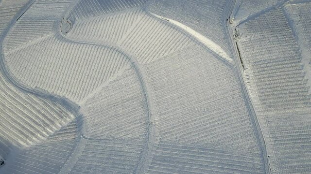 Aerial View Of Snowy Vineyards Near Zell-Weierbach In Offenburg, Germany During Winter Season. pull-away drone shot