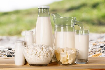 Glass of milk and dairy products on background
