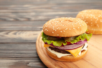 Homemade burger ingredients arranged on brown wooden background