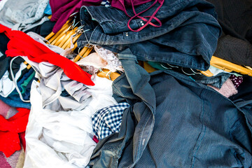 Mess in the wardrobe. Decluttering wardrobe. Sorting second-hand clothes for recycling.