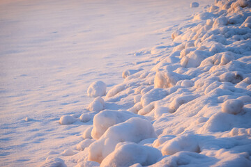 Cleaned snow on the side of the sidewalk. Winter weather background. Nobody