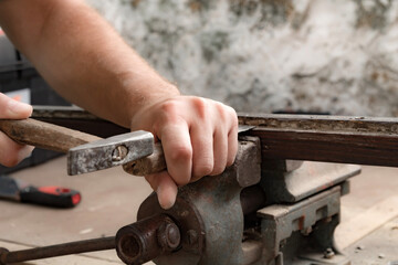 Male carpenter working on old wood in a retro vintage style.