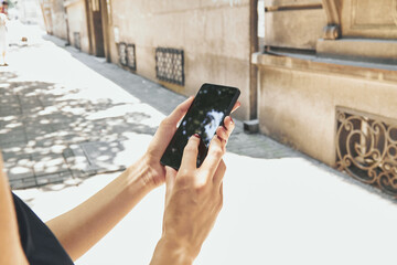 Woman using modern smartphone on the street.