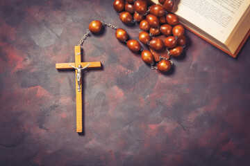Big wooden Rosary beads and crucifix cross with jesus and bible book,spiritual atmosphere ,religion concept.