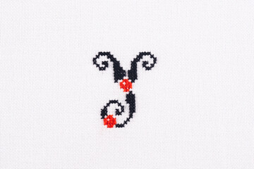Letter Y of Embroidered Cross - Stitch Latin Alphabet on White Linen Fabric Handmade Close-up