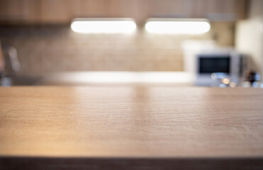blurred kitchen interior and wooden desk space home background