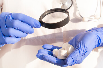 Pharmacist or expert on pharmaceutical inspection identifies pills. Testing, verification and...