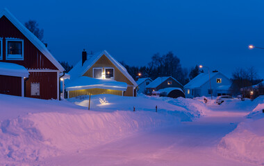 lights in houses in the evening in winter with snow