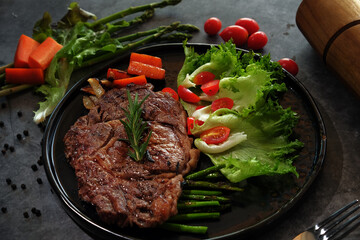 Beef Steaks in a Hot Plate on a Dark Floor