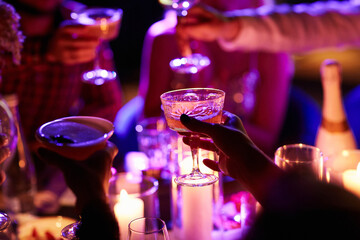 Close up of people drinking cocktails in restaurant. People having good time, cheering and drinking...