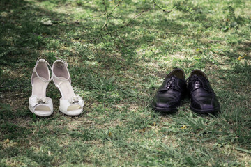 wedding women's and men's shoes on green grass