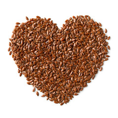 Whole linseed in heart shape isolated on white background