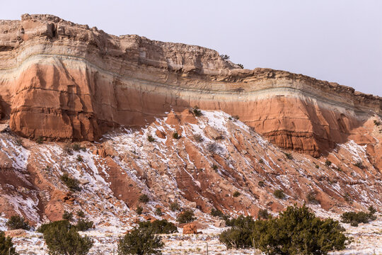 Differing Color Formations On Mountainside With Snow On Clear Day In Rural New Mexico