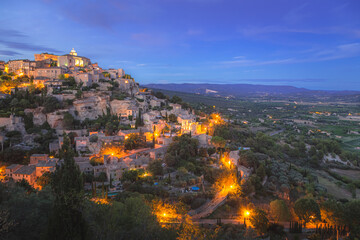Fototapeta na wymiar A stunning summer's evening view of the beautiful and historic hilltop village of Gordes, in Provence France