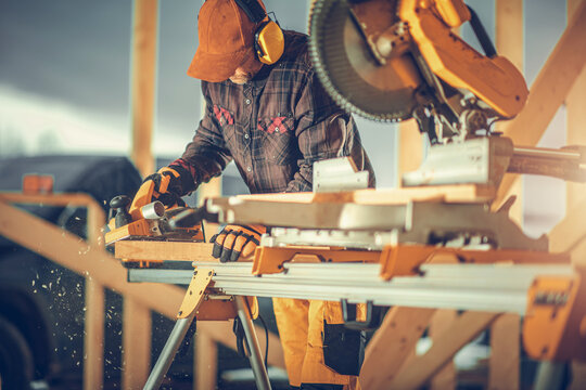 Construction Worker Planing Wood with Electric Planer