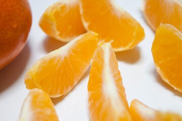Fototapeta na wymiar Isolated citrus segments. Collection of tangerine, orange and other citrus fruits peeled segments isolated on white background with clipping path