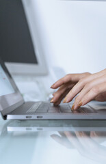 Female hands typing on laptop computer connected to wifi working on freelance, keyboarding on modern netbook for searching information online in networks for online
