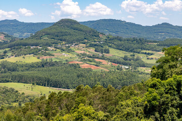 Forest over mountain, valley and farm plantation