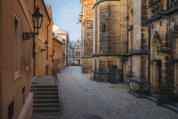 Evening golden light along the ancient pathway beside St. Vitus Cathedral on the grounds of Prague Castle.