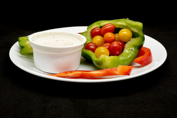 A vegetables plate with ranch sauce