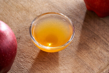 Apple cider vinegar in a bowl with fresh apples