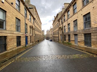 Looking down, Burnett Street, lined with Victorian stone built warehouses in, Little Germany, Bradford, UK
