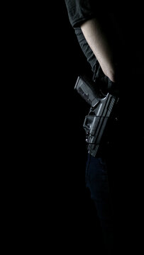 A woman openly carrying a handgun on her hip
