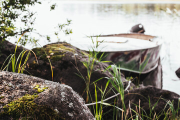 Stone with moss in the foreground. boat in the background
