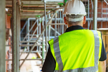 Rear View of a Construction Worker or Builder on Building Site - 410190645