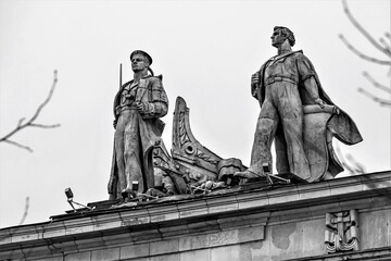 Russia, St. Petersburg, January 2021. Vintage figures of a revolutionary sailor and a worker on the roof of a building.