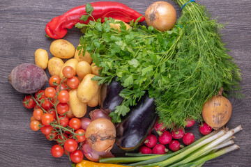 Fresh colorful organic vegetables on a rustic wooden table background.