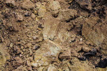 Red clay soil dump in construction pit. Close-up.