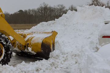 Snow removal tractor clears the road after heavy snowfall.
