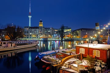  Illuminated Berlin at winter night against the Spree river, historical harbor in the downtown with old boats  © golovianko