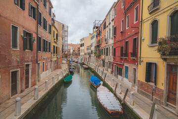 Fototapeta na wymiar Boats parked along a quiet canal in Venice, Italy