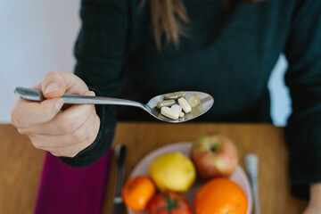 Woman is eating a pills and drugs. Concept of healthy food, diet.