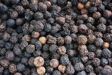 Organic whole black peppercorns background